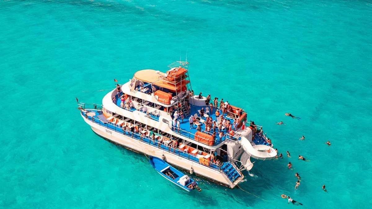 Three-story party catamaran on a Cancun yacht rental style day cruise to Isla Mujeres, Quintana Roo, Mexico