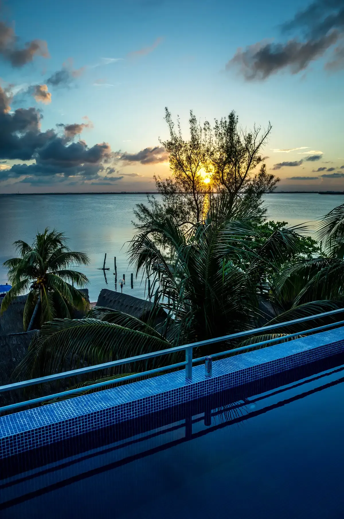 Sunset over the calm Nichupte Lagoon in Cancun seen from a lagoon side deck, a setting for Cancun yacht rentals
