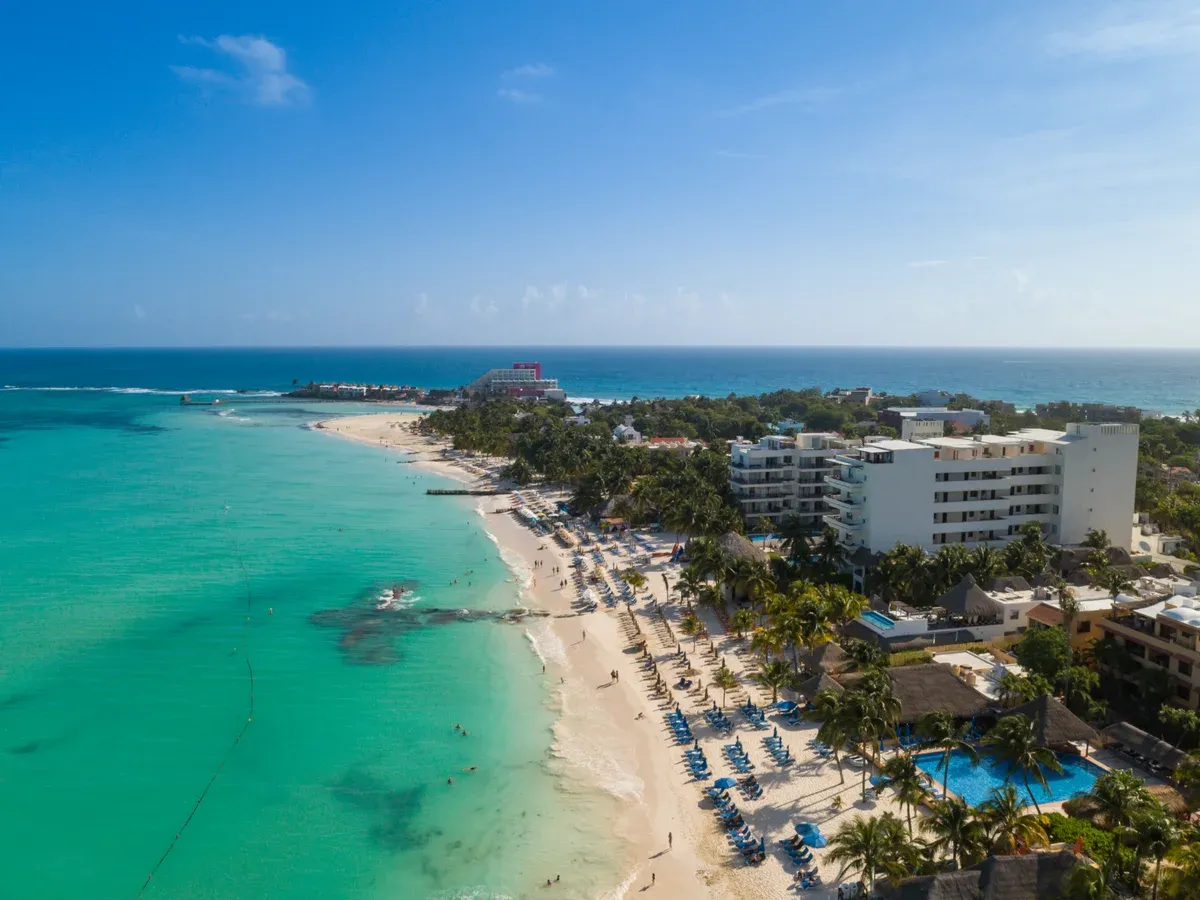 Aerial view of Playa Norte on Isla Mujeres with shallow turquoise water, named on several Cancun yacht rental routes
