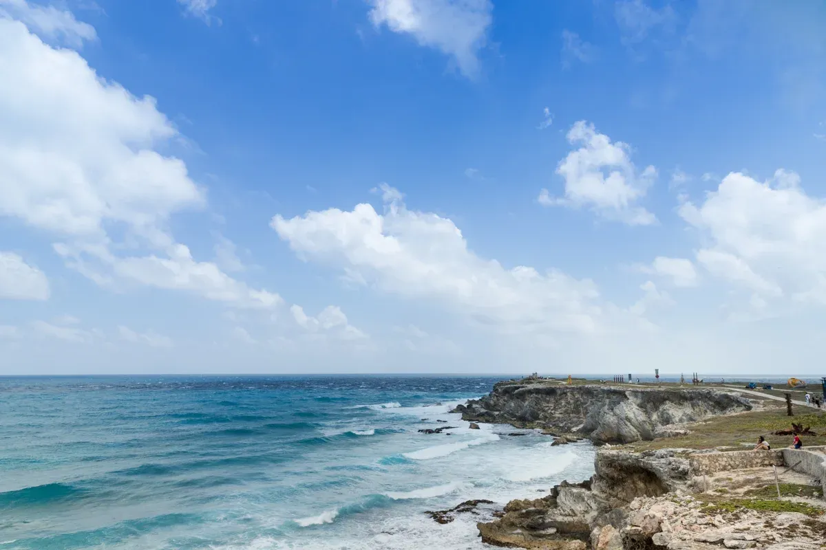Limestone cliffs and surf at Punta Sur on the southern tip of Isla Mujeres, a stop on Cancun yacht rental routes